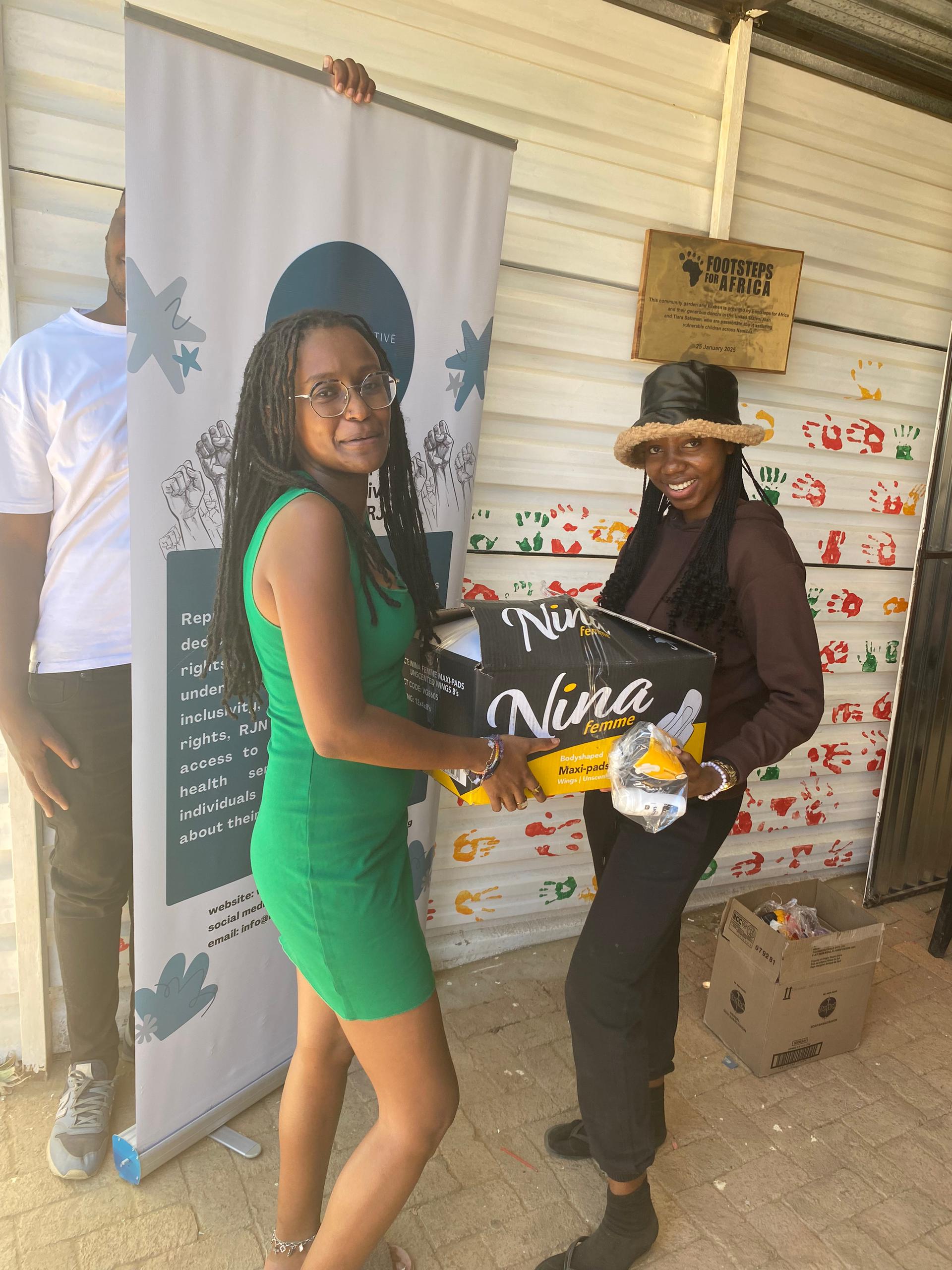RJN outreach team handing over sanitary pads