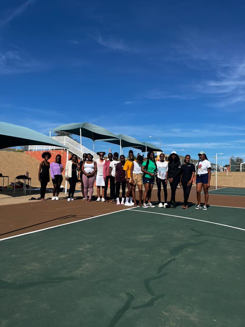 Group standing on an outdoor sports court