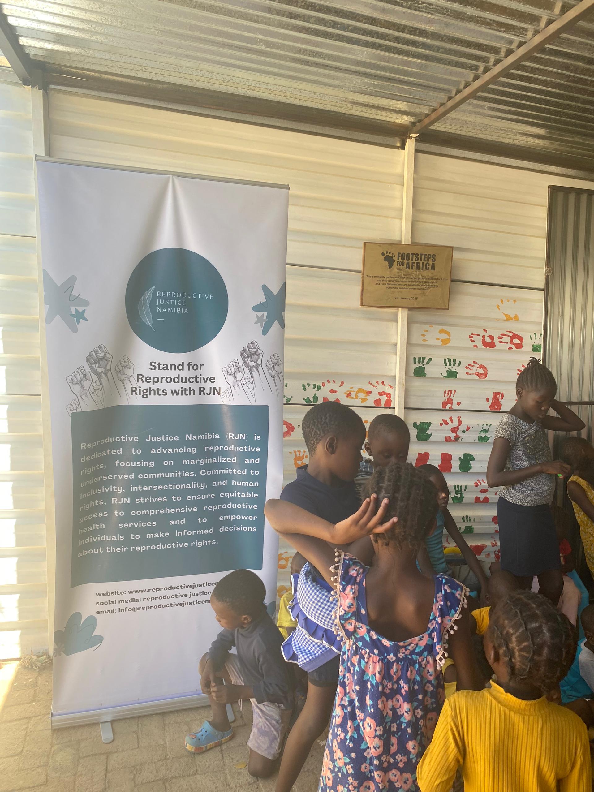 RJN banner beside a community outreach gathering